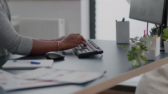 Closeup of Teenager with Dark Skin Hands on Keyboard Typing Email on Computer