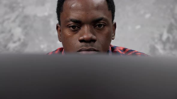 Close Up Face African American Businessman Works Laptop Chatting with Employees