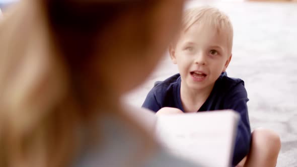 Little boy talking to teacher in the preschool