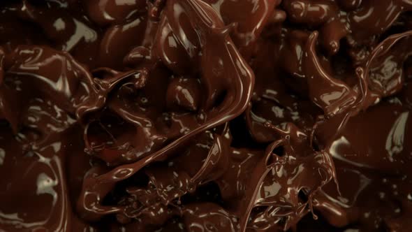 Super Slow Motion Shot of Splashing Melted Chocolate Background at 1000 Fps alt