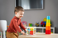 A cute little toddler boy of two years old plays with multi-colored balls - PhotoDune Item for Sale