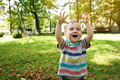 Happy toddler boy playing in the park on a sunny day. Smile boy of one and a half years outdoors.  - PhotoDune Item for Sale