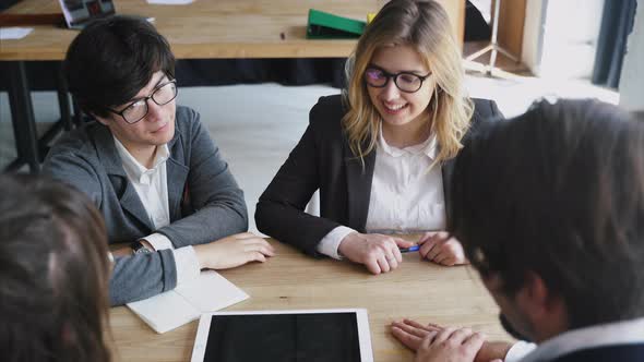 Business People With Digital Tablet Having Meeting In Office