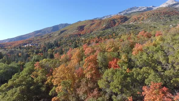 A drone flies over the rocks and slopes of  Dry Creek Trailhead in Alpine, Utah as leaves change int