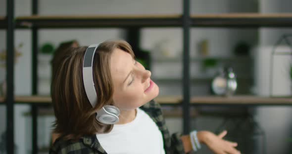 Woman in Wireless Headset Is Dancing in Living Room, Close Up