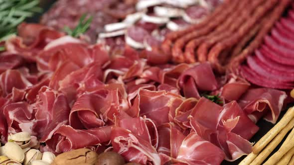 French or Italian appetizers - sliced prosciutto, sausage, ham, boiled pork, balyk, jamon, sandwich,