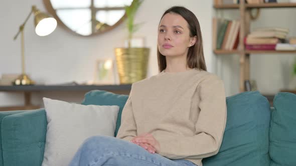 Casual Young Woman Sitting on Sofa