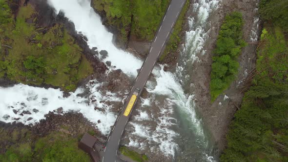 Truck driving over bridge in Norwegian highlands, Latefossen Waterfall, aerial