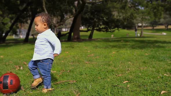 Boy Playing with Ball in Park, Trying To Playing Pass, Smiling