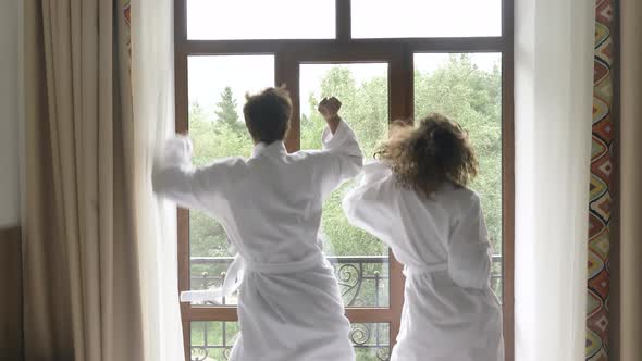 Man and Lady Dance Clap Hands and Kiss Standing Near Balcony