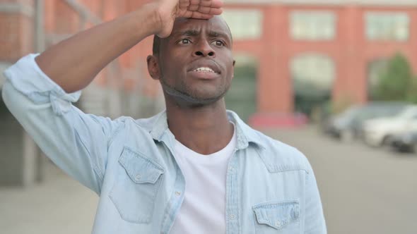 Outdoor Portrait of African Man Looking Around Searching