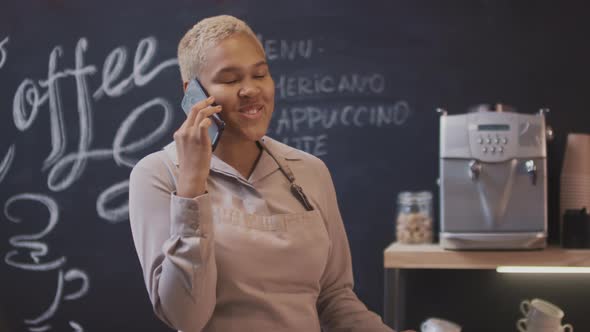 Coffee Seller Talking On Phone Smiling