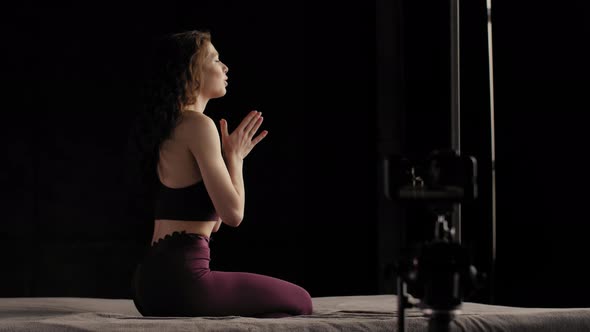 A Young Girl in Lilac Sportswear Conducts an Online Yoga Class. Takes a Picture of Himself on a Cell