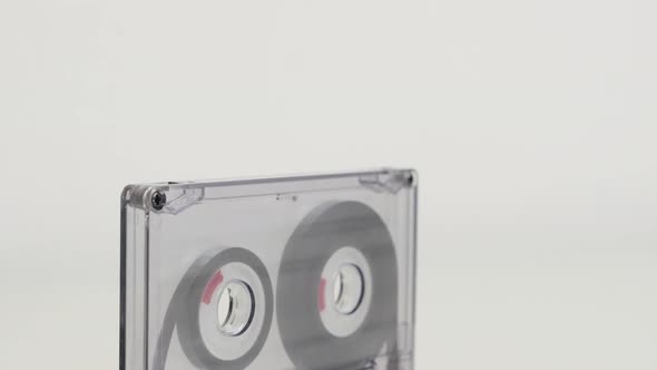 Compact  audio cassette on white background 4K 2160p 30fps UltraHD tilting footage - Transparent ana