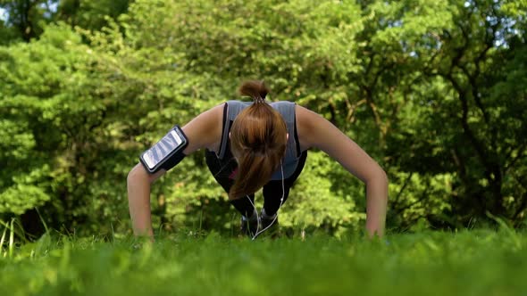 Girl Doing Pushups on the Nature