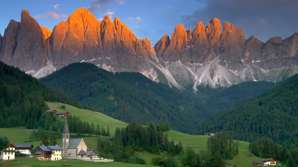 Alpine Village Santa Maddalena with Dolomites Mountains at Sunset, Panning Shot