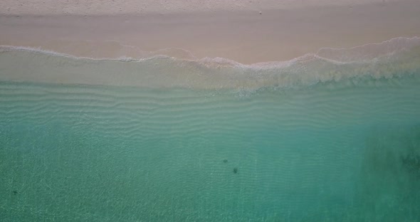 Tropical fly over tourism shot of a sunshine white sandy paradise beach and blue ocean background in