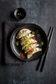 A plate with fresh gyoza dumpling on black plate and background with chopsticks - PhotoDune Item for Sale
