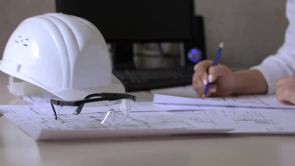 Construction engineer makes notes on the drawings