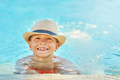 Picture of young boy in hat playing in outdoor swimming pool - PhotoDune Item for Sale