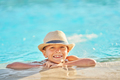 Picture of young boy in hat playing in outdoor swimming pool - PhotoDune Item for Sale