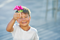 Picture of young boy smiling with flower in his hand. - PhotoDune Item for Sale