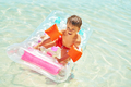 Picture of young happy boy swimming on mattress on Red Sea - PhotoDune Item for Sale