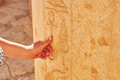 Image of hand touching Egyptian hieroglyphs in Mortuary Temple of Hatshepsut - PhotoDune Item for Sale