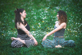 Couple of young women look at each other during a yoga session - PhotoDune Item for Sale