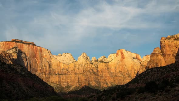 Time lapse of cliffs lighting up at sunrise in Zion National Park