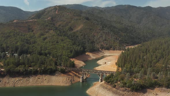 Aerial view of bridge over Shasta Lake in Northern California low water levels during drought