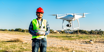 Selective focus of a drone operated by a Caucasian construction worker in a construction site