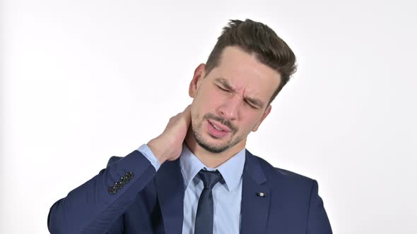 Portrait of Stressed Young Businessman Having Neck Pain, White Background