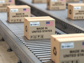 Made in USA. Cardboard boxes with text made in United States and  US flag on the roller conveyor. - PhotoDune Item for Sale