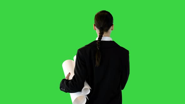 Young Woman in Office Suit Walking with Papers in Hands on a Green Screen Chroma Key