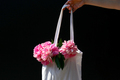 the girl holds a bag with summer flowers peonies. summer mood, lifestyle. - PhotoDune Item for Sale