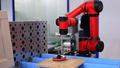 An automated robotic arm polishing a wooden surface. High-tech industrial production. - PhotoDune Item for Sale