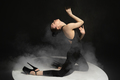 Dynamic portrait of young flexible dancer dancing isolated on dark studio background in spotlight. - PhotoDune Item for Sale
