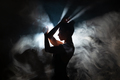 Dancer in a modern style poses against the background of smoke and flood lights. - PhotoDune Item for Sale