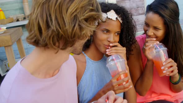 Happy friends having juice