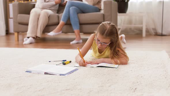 Student Girl with Notebook Lying on Floor at Home