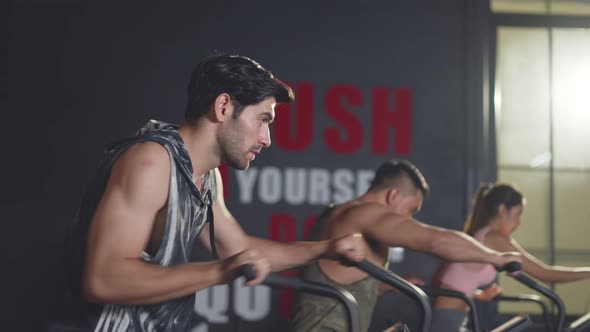 Group of multiethnic fitness man and woman using exercise bikes exercise for health in gym stadium.