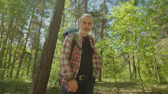 Handsome Middle Aged Tourist Man Enjoying Backpacking Holidays in Woodland