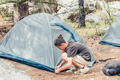 Teenager boy setting up tourist tent. Summer travel, camping and hiking concept. - PhotoDune Item for Sale