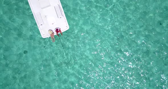 Happy couple on honeymoon vacation live the dream on beach on clean white sand background 4K