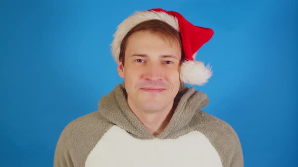 Handsome Man in Santa Hat Looking at Camera and Smiling