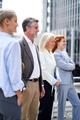 Vertical image of business people standing outdoors looking forward. - PhotoDune Item for Sale