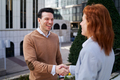 A businessman shaking hands with his female colleague outdoors - PhotoDune Item for Sale