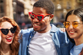 A group of friends hanging out together in the city wearing sunglasses and laughing - PhotoDune Item for Sale