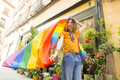Happy young person waving pride flag - PhotoDune Item for Sale